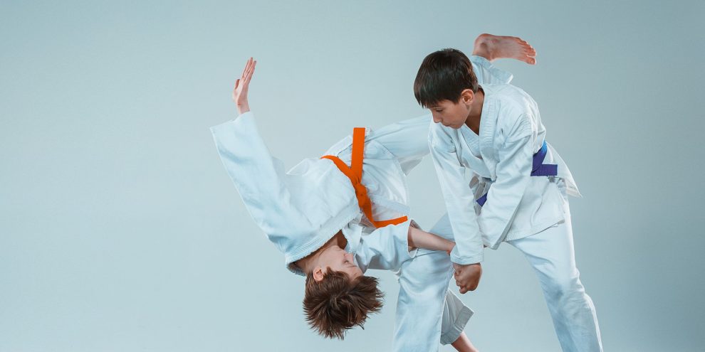 The two boys fighting at Aikido training in martial arts school. Healthy lifestyle and sports concept