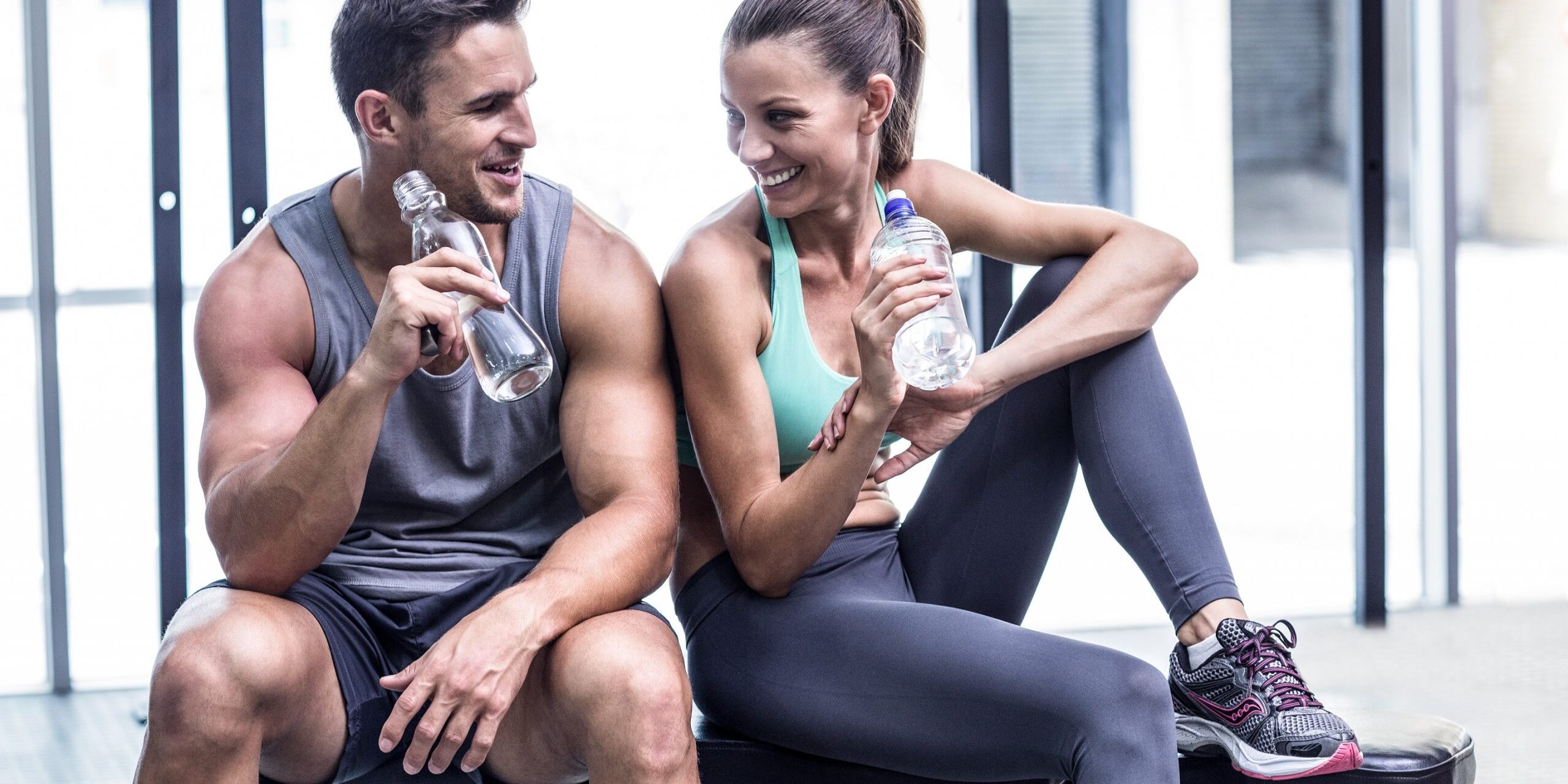 Muscular couple discussing on the bench